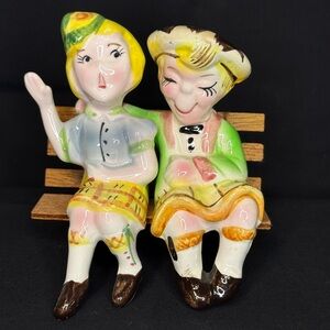 Colorful Ceramic Figurines on Bench